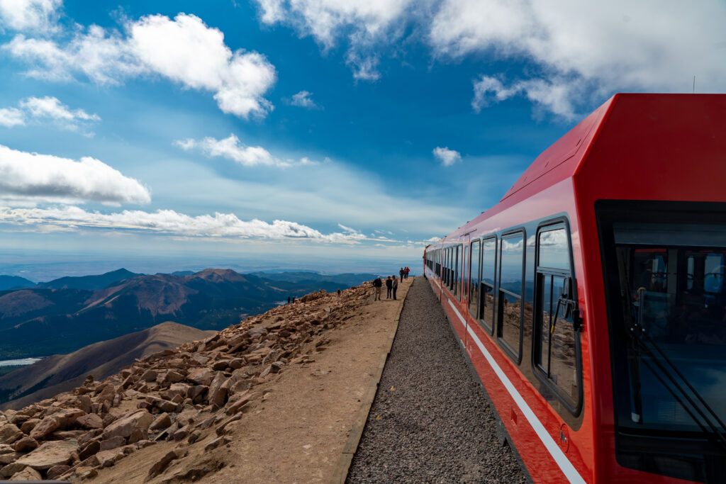 A view of a pikes peak cog railway train waiting to load passengers for their return trip to the lower station